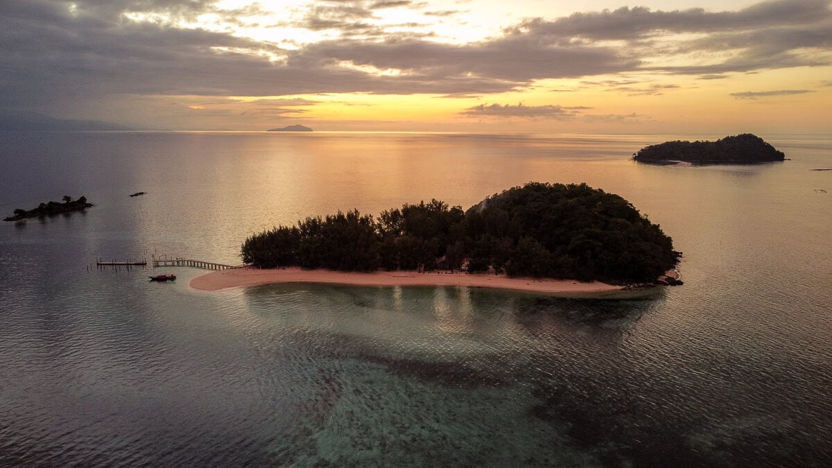 Sonnenuntergang über der Celebes See in Indonesien mit Insel im Vordergrund